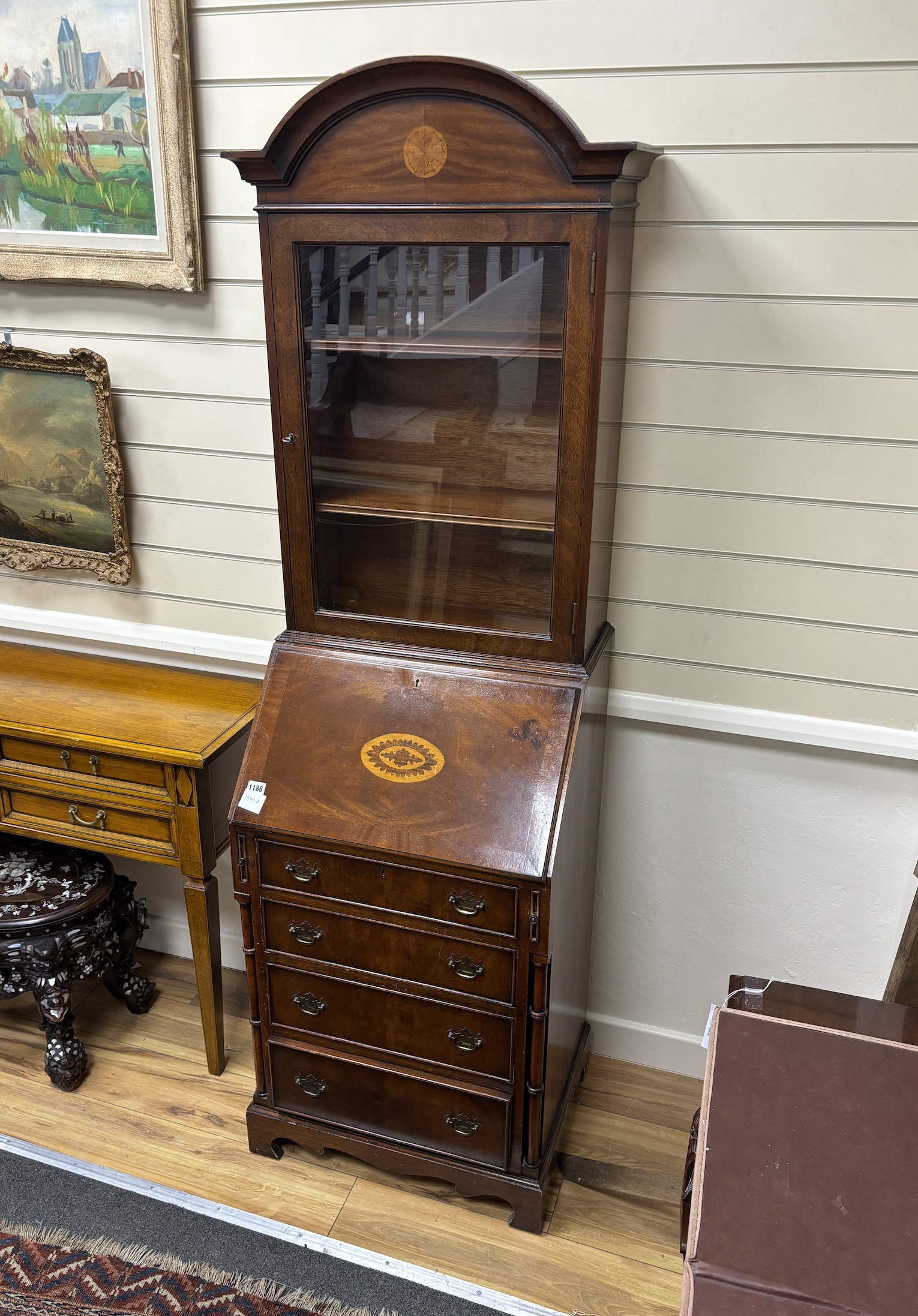 A reproduction George III style inlaid mahogany bureau bookcase, of narrow proportions, width 55cm, depth 44cm, height 184cm